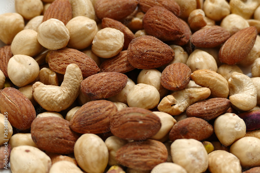 nuts, cashew nuts, dry almonds all close up on a plate, dry foods on black ground, nuts, nuts, peeled hazelnuts, cashews and almonds, stand together, nuts, cashew nuts, dry almonds all close up on a plate, dry foods on black ground, nuts, nuts, peeled hazelnuts, cashews and almonds, stand together,