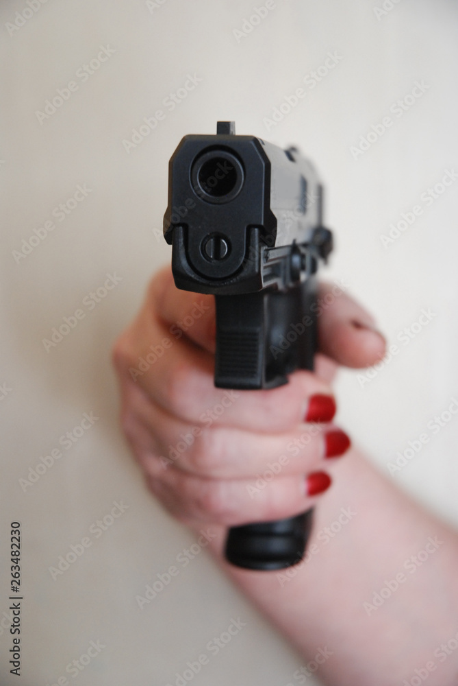 Wooman's hand with pistol Wooman's hand with pistol