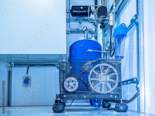 Compressor installation. Belt compressor. Compressor equipped with pressure gauge. Compressed air production. Electrical equipment. Power industry.