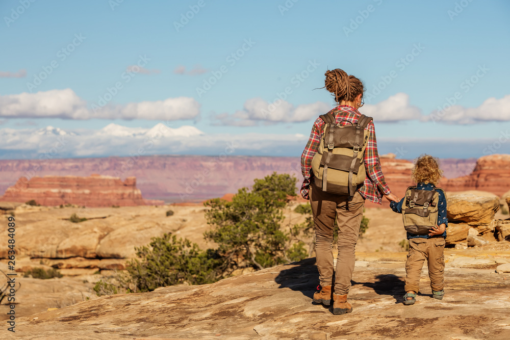 Hiker with boy in Canyonlands National park, needles in the sky, in Utah, USA Hiker with boy in Canyonlands National park, needles in the sky, in Utah, USA