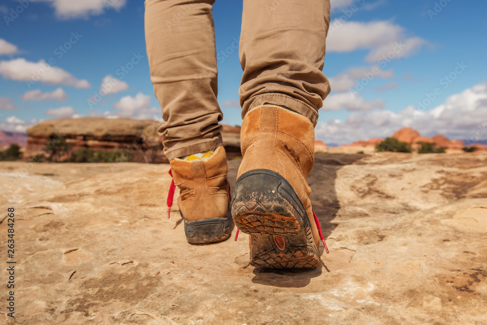 Womens trekking shoes while hiking in mountains Womens trekking shoes while hiking in mountains
