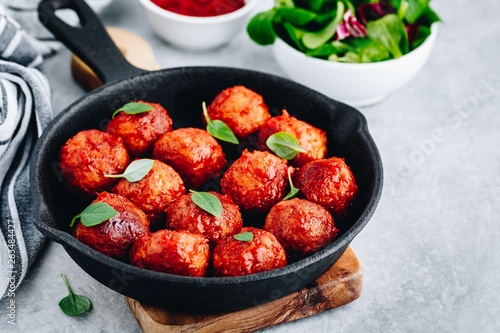 Homemade beef or chicken meatballs in tomato sauce in a frying pan