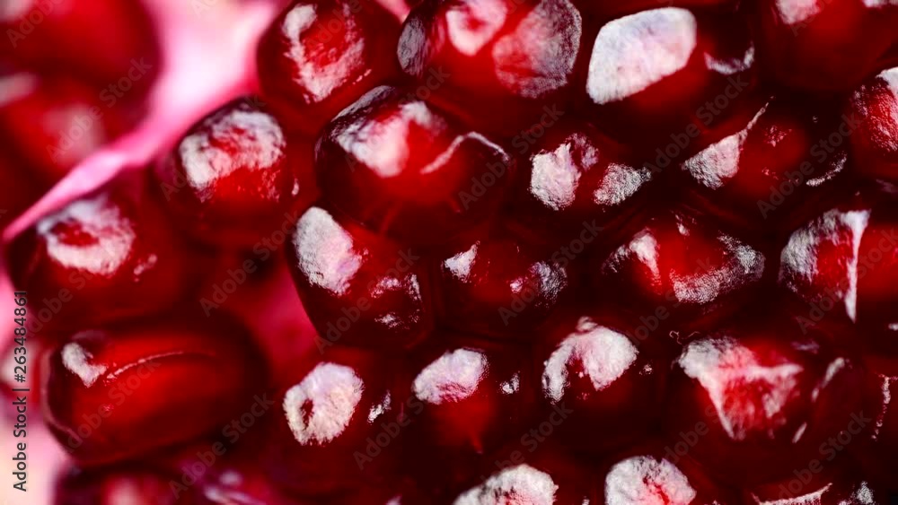 Close-up of rotating india pomegranate Seeds on black background in 4K resolution Close-up of rotating india pomegranate Seeds on black background in 4K resolution