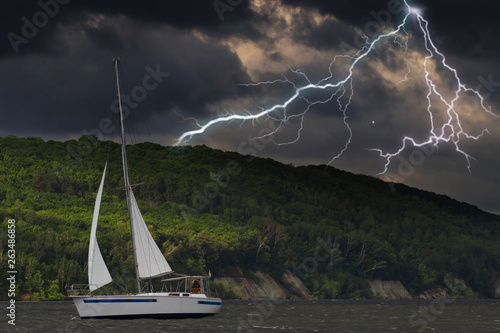 Sailing yacht in a stormy weather with lightning