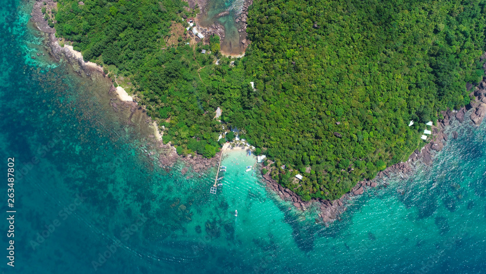 Top view or Aerial view of tropical island jungle with palms and emerald clear water of island .Royalty high quality stock image in Phu Quoc, Kien Giang, Vietnam