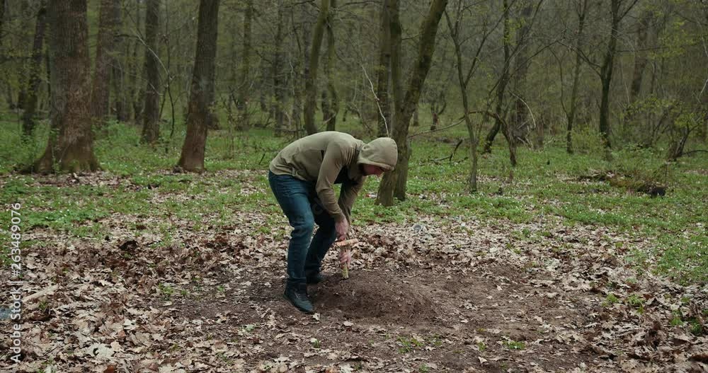 The Guy Sets A Homemade Cross On The Grave Of A Dead Pet. Dog Funeral, Grave With A Cross. Close Up. Prores, Slow Motion The Guy Sets A Homemade Cross On The Grave Of A Dead Pet. Dog Funeral, Grave With A Cross. Close Up. Prores, Slow Motion