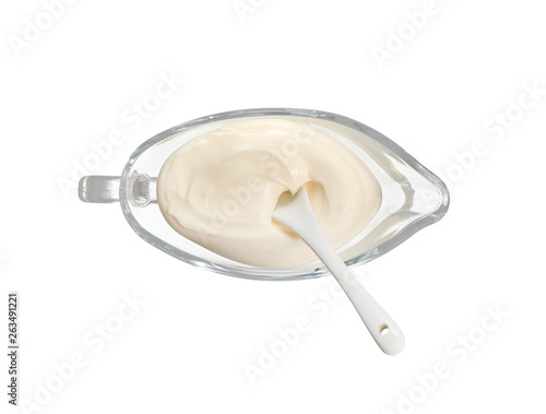 White cream sauce with a white spoon in a glass plate isolated on white. Top view. With clipping path