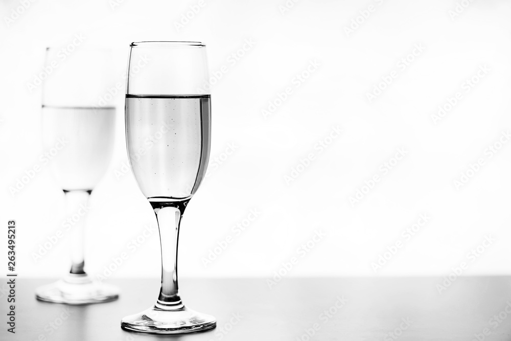 monochrome photo of champagne on white table on white background isolate monochrome photo of champagne on white table on white background isolate