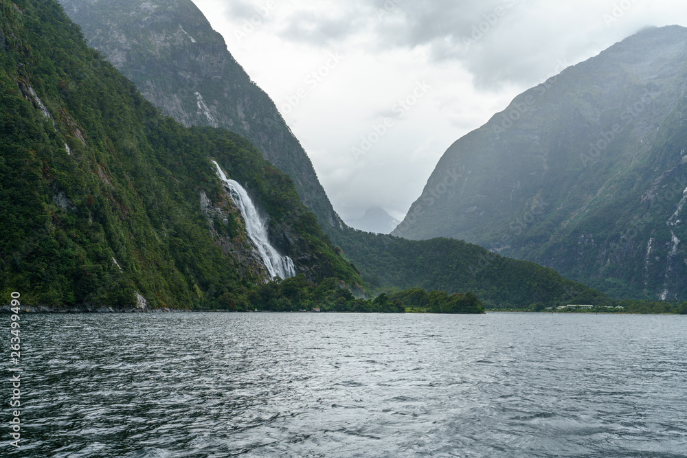 waterfall in the mountains at milford sound, fjordland, new zealand 16