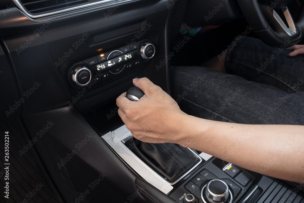 Fototapeta premium Hand on shifting gear on car ,man driving car.