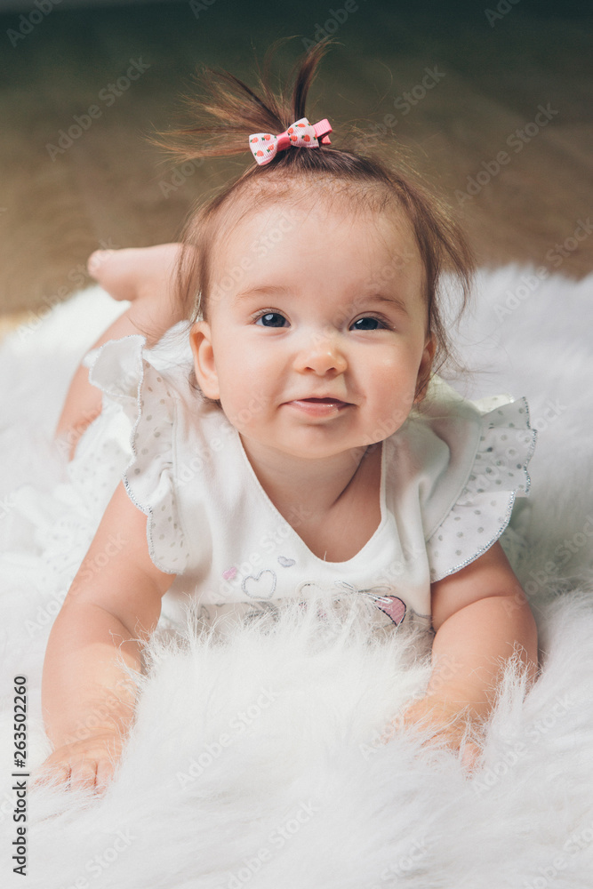 little girl with a tail on her head crawling on the floor little girl with a tail on her head crawling on the floor