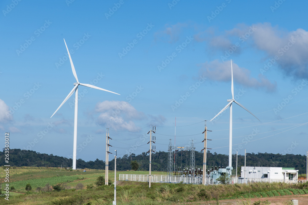 Wind turbines farm on the mountains; blue sky, white clouds