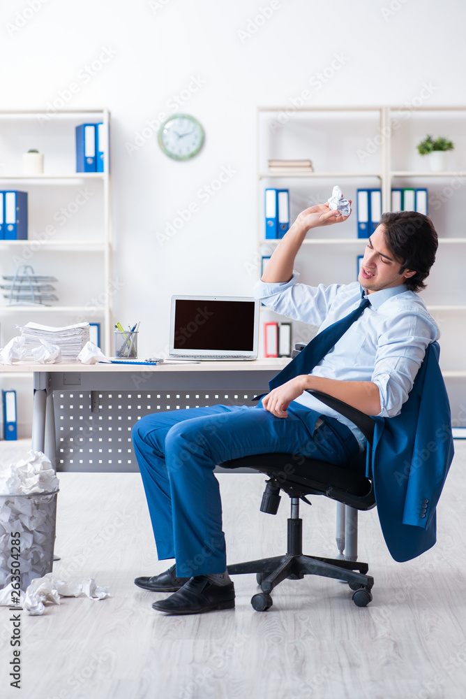 Businessman rejecting new ideas with lots of papers Businessman rejecting new ideas with lots of papers