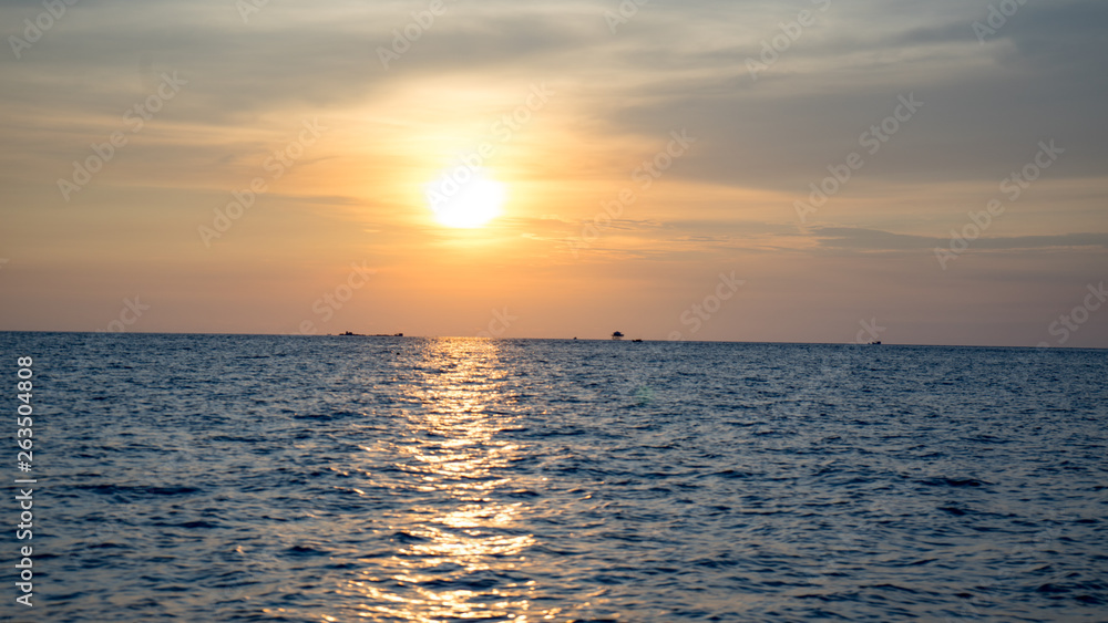 Landscape of beautiful sunset in Phu Quoc island sandy beach with colorful sky and dramatic clouds over wavy sea Landscape of beautiful sunset in Phu Quoc island sandy beach with colorful sky and dramatic clouds over wavy sea