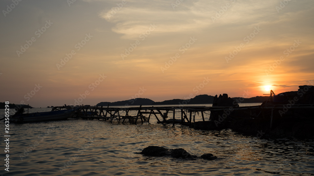 Landscape of beautiful sunset in Phu Quoc island sandy beach with colorful sky and dramatic clouds over wavy sea	