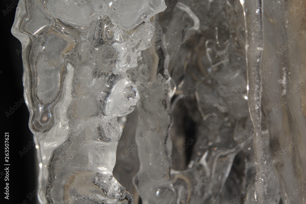 Icicles hanging on a ledge with rocky bacground Icicles hanging on a ledge with rocky bacground