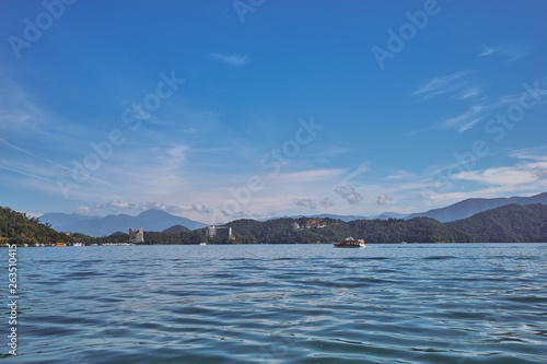 Nantou, Taiwan - December 8, 2018: Tourist on boat enjoy to see Sun Moon Lake with the surrounding mountains are the highlight at this sprawling lake at Yuchi, Nantou in Taiwan. photo