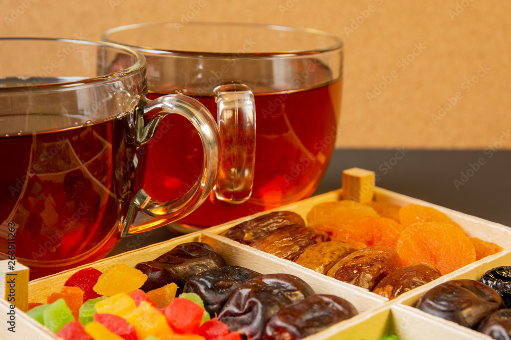 Oriental sweets, dried fruit with a cups of tea Oriental sweets, dried fruit with a cups of tea