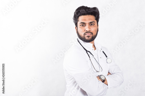 Handsome young doctor in a white coat with a stethoscope. Health care concept.