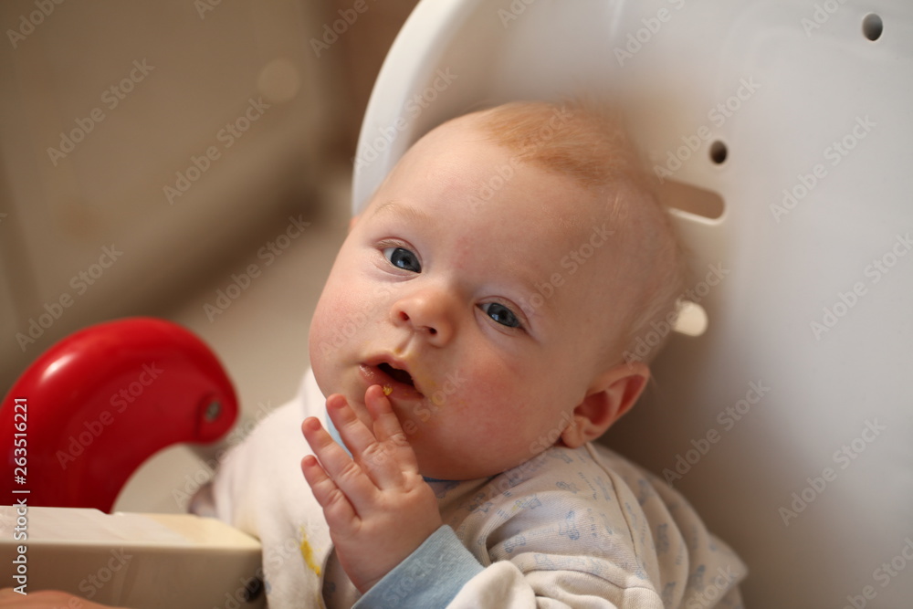 A child of 6 months pedagogical feeding from a spoon of porridge. A child of 6 months pedagogical feeding from a spoon of porridge.