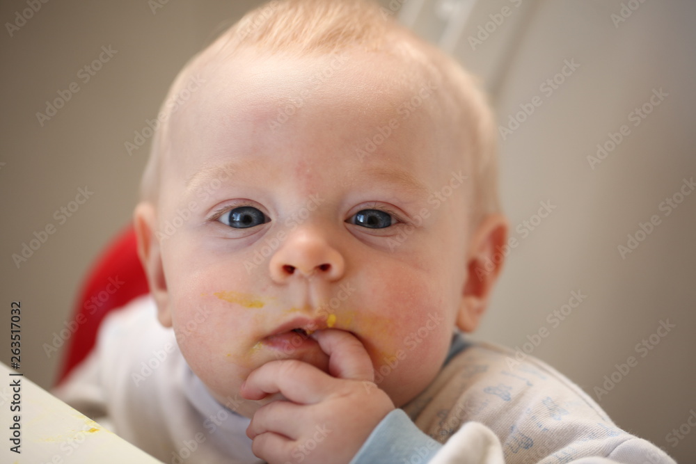 A child of 6 months pedagogical feeding from a spoon of porridge. A child of 6 months pedagogical feeding from a spoon of porridge.
