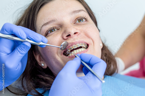 Young woman at the dentist braces check up