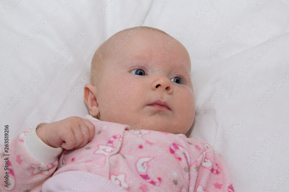 baby with blue eyes,beautiful baby was lying on a white blanket in a crib baby with blue eyes,beautiful baby was lying on a white blanket in a crib