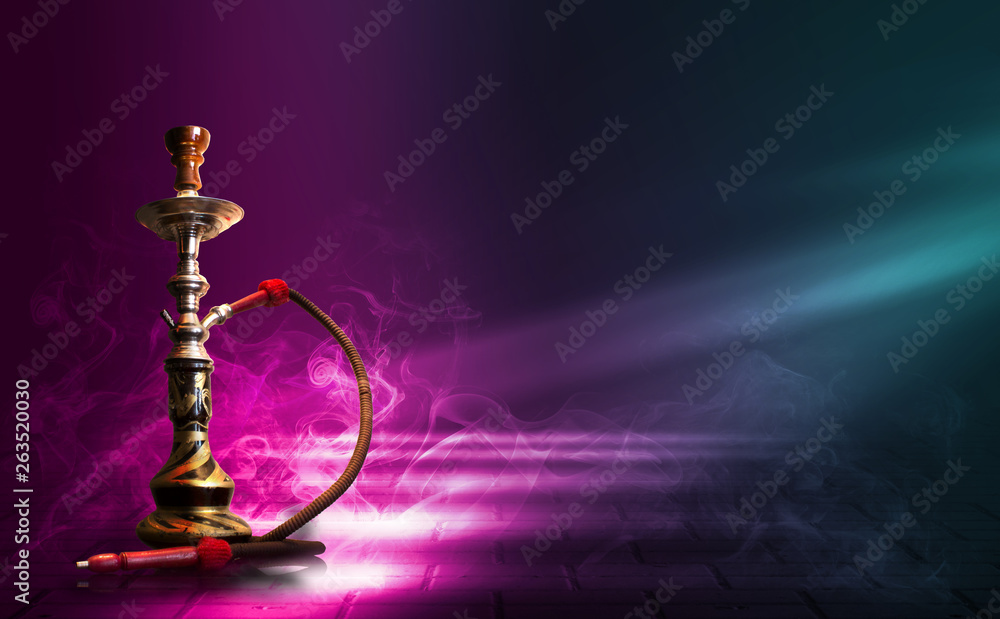 Hookah, smoke on a dark abstract background. Background of empty scenes with multicolored neon lights, reflection of night lights on wet pavement Hookah, smoke on a dark abstract background. Background of empty scenes with multicolored neon lights, reflection of night lights on wet pavement