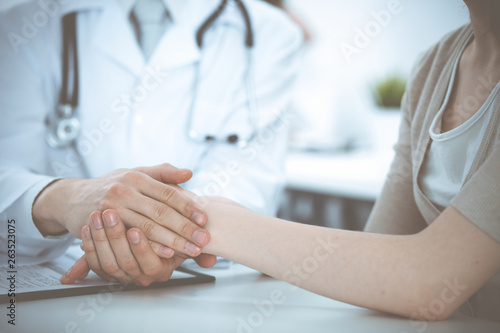 Hand of doctor reassuring her female patient. Medicine and health care concept