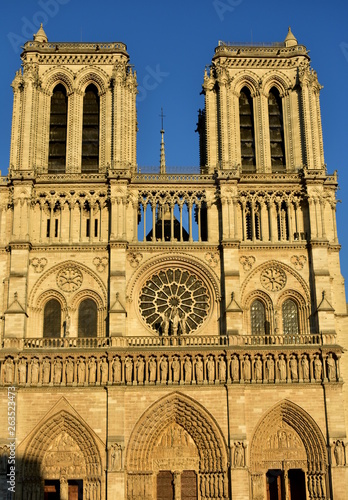 Notre Dame, Paris, France. Facade and spire with sunset light.