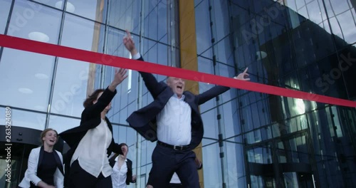 Business people crossing the finish line