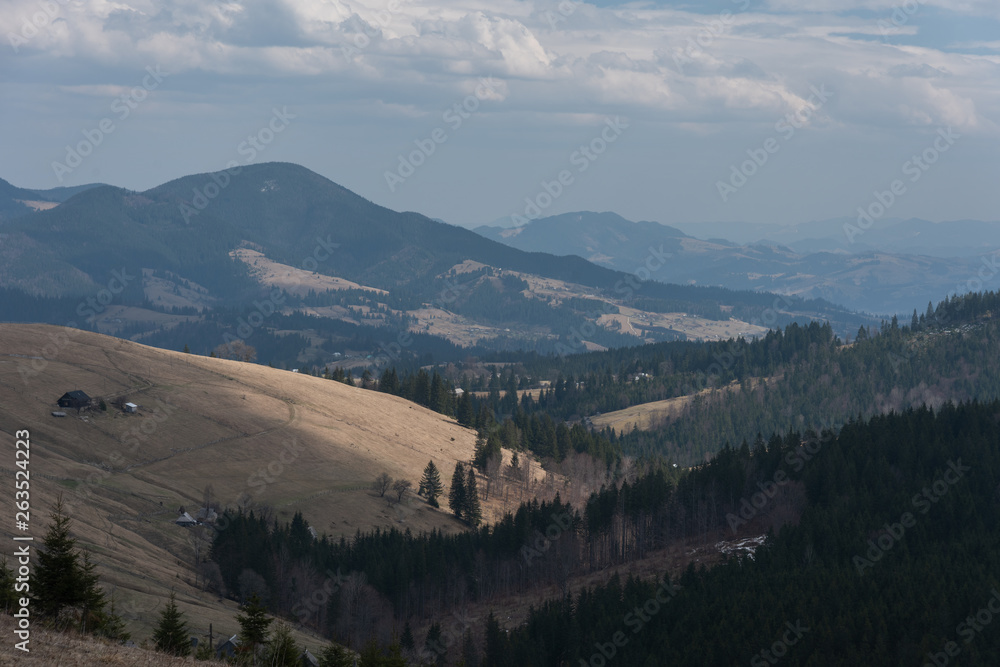 mountain views with cloudy sky and traveling tourists in the Ukrainian Carpathians