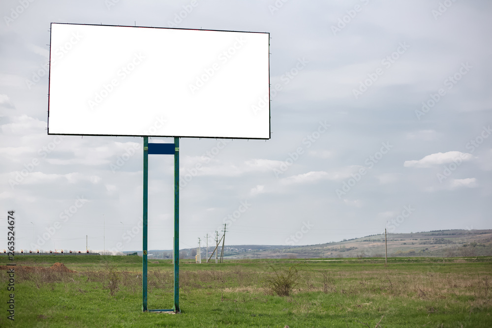 Empty billboard blank for advertising in green field.