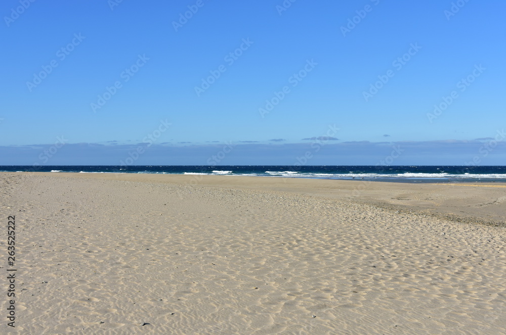 Beach with waves and blue sky. Galicia, Spain.