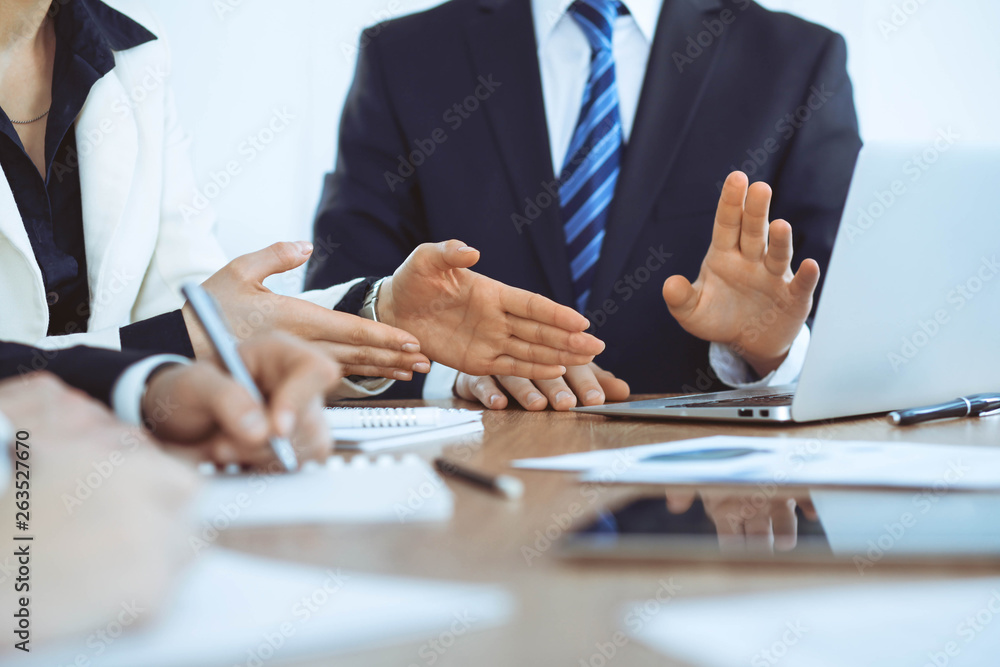Group of businesspeople or lawyers discussing contract papers and financial figures while sitting at the table. Close-up of human hands at meeting or negotiations. Success and communication concept Group of businesspeople or lawyers discussing contract papers and financial figures while sitting at the table. Close-up of human hands at meeting or negotiations. Success and communication concept