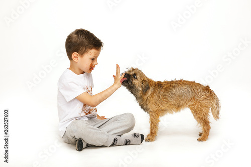 little boy in chocolate with his dog