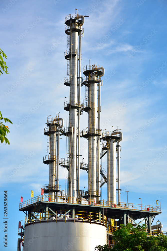 Close-up of pipelines and destillation tanks of an oil-refinery plant Close-up of pipelines and destillation tanks of an oil-refinery plant