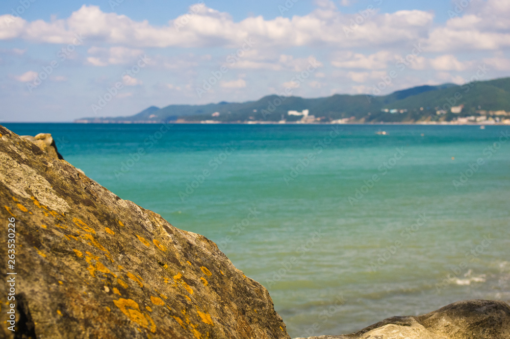 rocky sea shore with pebble beach, waves with foam rocky sea shore with pebble beach, waves with foam
