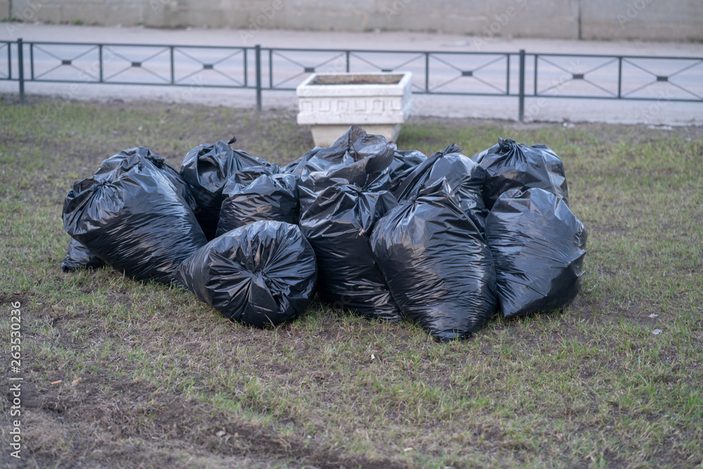 spring cleaning, black plastic trash bags full of garbage. spring cleaning, black plastic trash bags full of garbage.