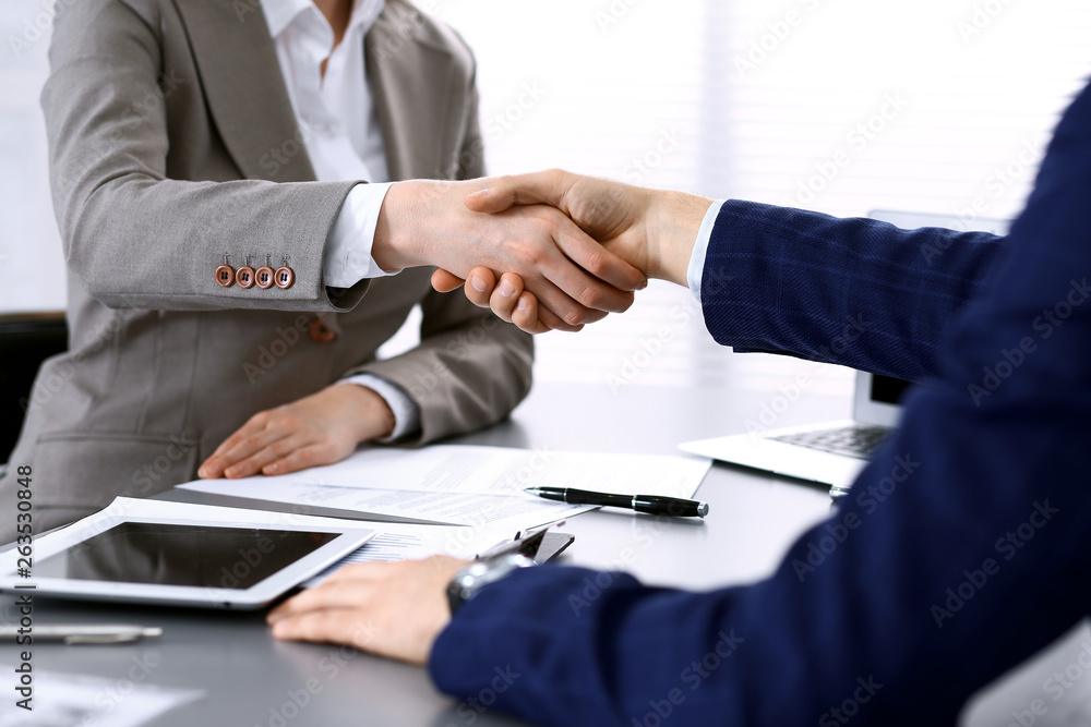 Business people shaking hands, finishing up a meeting. Papers signing, agreement and lawyer consulting concept Business people shaking hands, finishing up a meeting. Papers signing, agreement and lawyer consulting concept