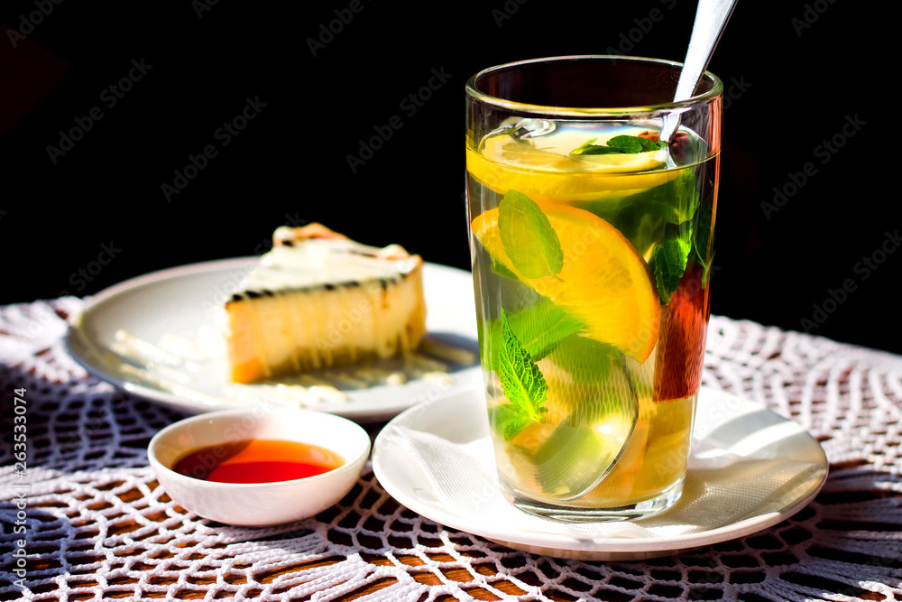 Fruit orange tea with mint, ginger and cinnamon. Orange slices in a glass cup close up Fruit orange tea with mint, ginger and cinnamon. Orange slices in a glass cup close up