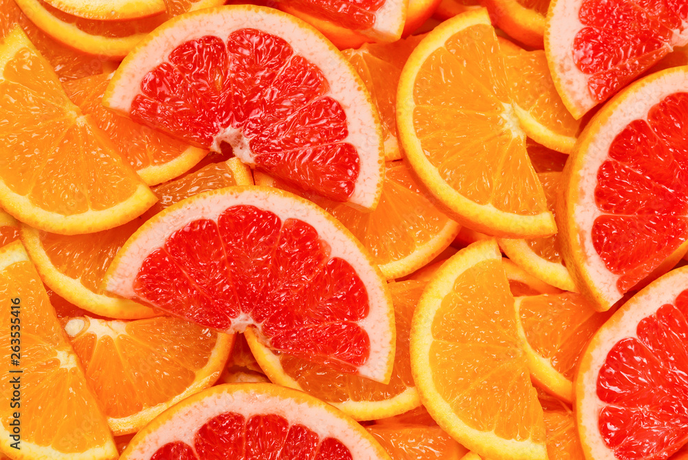 Slices of oranges and a grapefruits as a background. Slices of oranges and a grapefruits as a background.