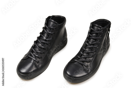 Men's black leather shoes and a black camera on a isolated on white background. Copy space.