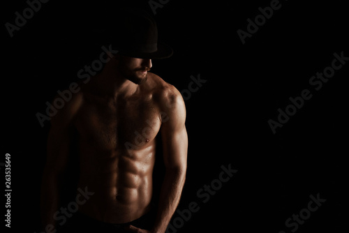 Muscular male bodybuilder on black background