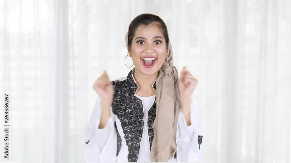 Cheerful young muslim woman looks surprised while looking at the camera in home. Shot in 4k resolution Cheerful young muslim woman looks surprised while looking at the camera in home. Shot in 4k resolution