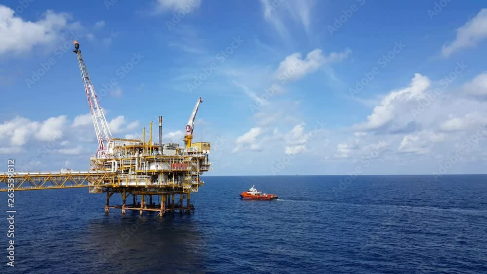 Songkhla, Thailand-February 08, 2019 : Red Supply boat transfer cargo to oil and gas industry and moving cargo from the boat to the platform. Boat is waiting transfer cargo and crews to platform. Songkhla, Thailand-February 08, 2019 : Red Supply boat transfer cargo to oil and gas industry and moving cargo from the boat to the platform. Boat is waiting transfer cargo and crews to platform.