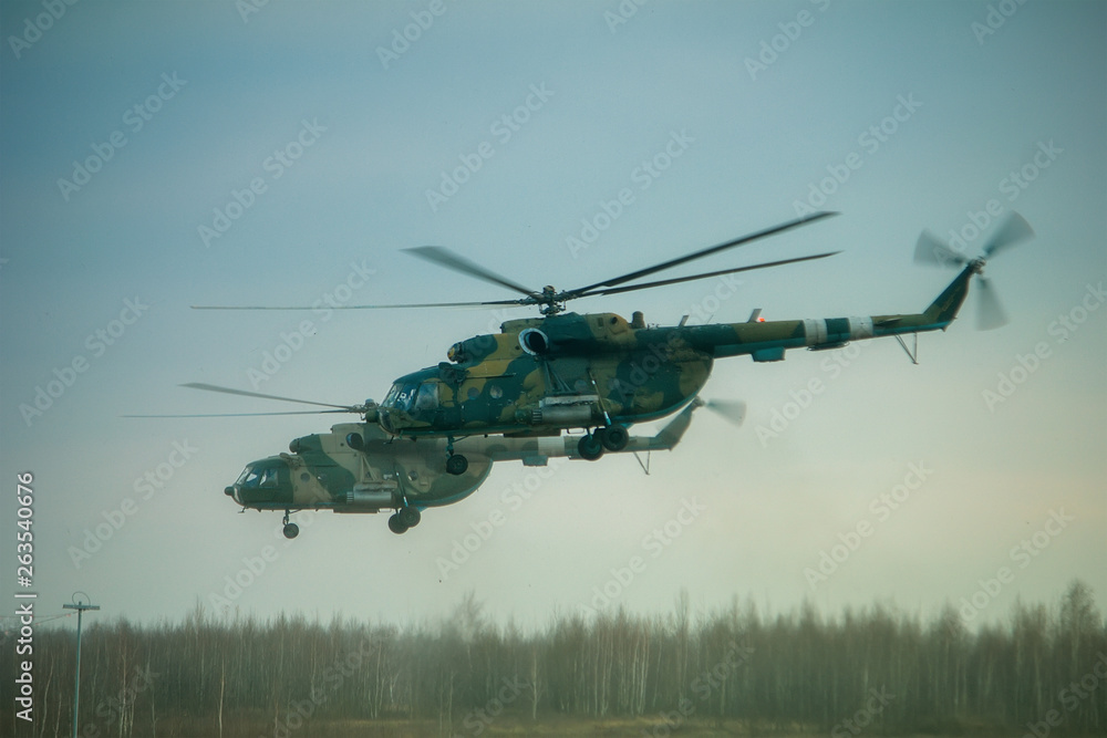 Helicopter in flight at sunset above war field Helicopter in flight at sunset above war field