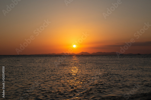 Beautiful golden sunset by the sea and the mountains. View from phra nang beach. Krabi © Dmitry Dven