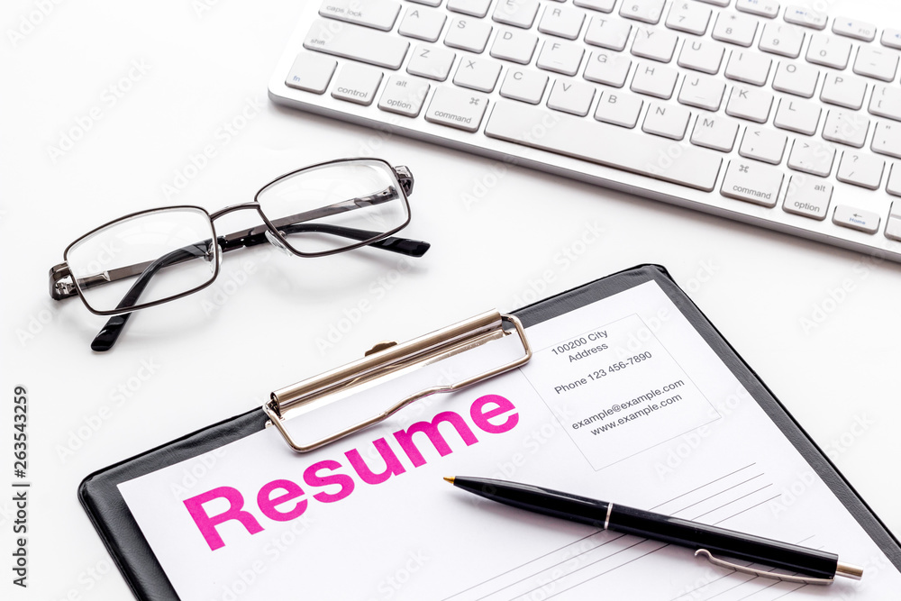 Create CV concept with pen, glasses, keyboard on white desk top view Create CV concept with pen, glasses, keyboard on white desk top view