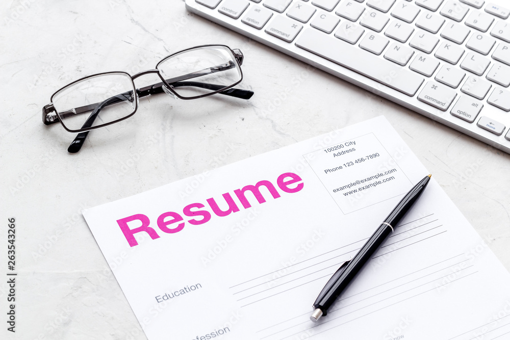 Review resumes of applicants set with keyboard and glasses white work desk background Review resumes of applicants set with keyboard and glasses white work desk background